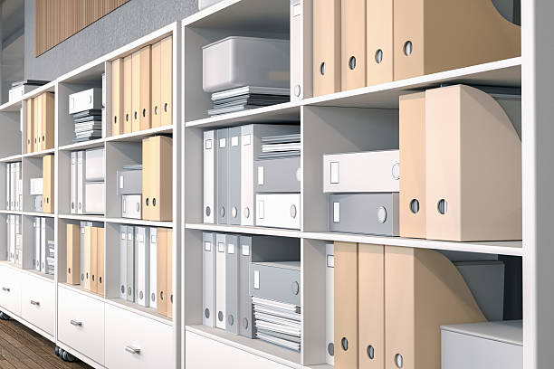 Bright, modern office archive with shelves filled with folders, binders, document boxes, and stacks of paperwork, set against a mix of wood and concrete surfaces. Used for physical data storage, categorisation, document retrieval, information management, administrative workflow, and paper record-keeping. Digitally generated 3D rendering.
