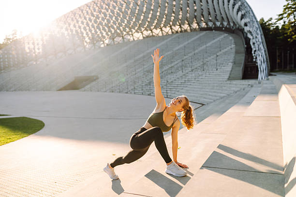 istock A sporty woman doing exercises outdoors at sunset. 2221897941