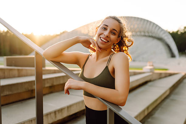 istock A sporty woman doing exercises outdoors at sunset. 2221897974