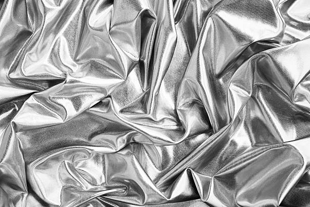 Black white light gray silver silver background. Crumpled shiny material fabric. Glitter shine metallic glossy foil shummer reflection. Curved fold wavy lines liquid. Design.