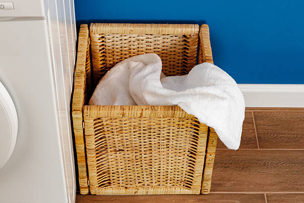 istock Washing machine with laundry on blue wall background 2221898465