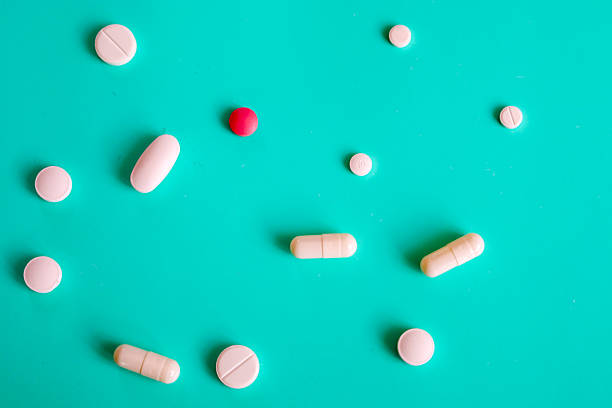 istock A scattering of white, pink, and light beige pills and capsules is randomly arranged on a vibrant turquoise background. This composition symbolizes modern medicine, pharmaceutical innovations, and the wide range of means for maintaining health. 2221902814