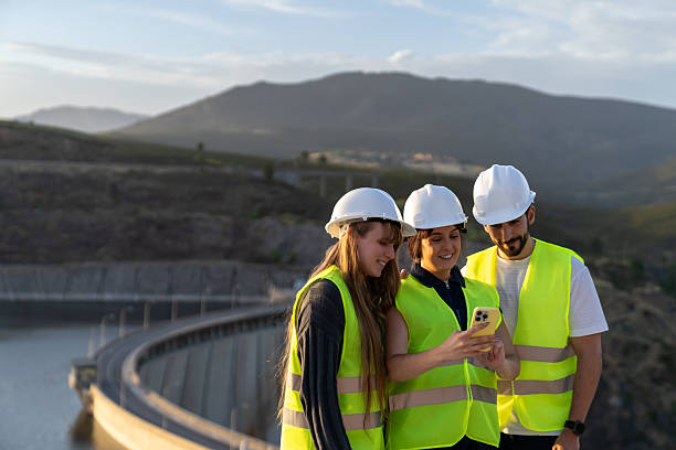 istock Engineers using smartphone near dam and reservoir 2221908531