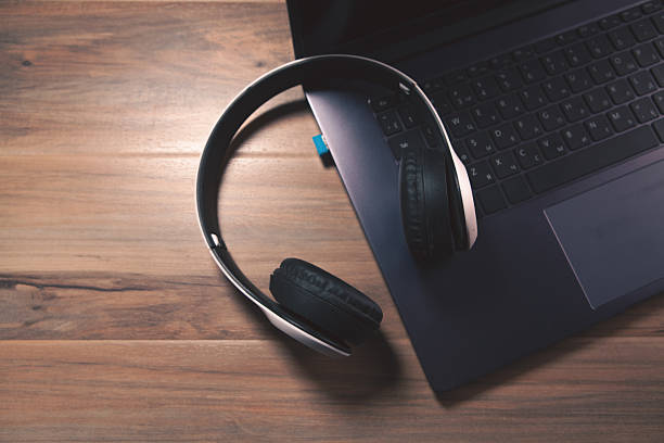 headphones and keyboard with laptop