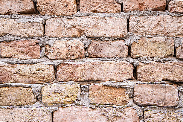 istock Close-Up of Textured Brick Wall with Natural Colors and Patterns 2221911131