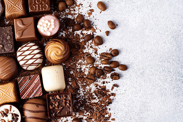 istock Chocolate candies and chocolate pieces pile for background 2221913207