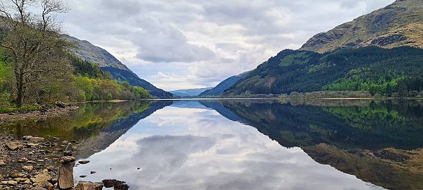 istock Idyllic Mountain Lake with Symmetrical Reflection and Verdant Forest Surround 2221915300