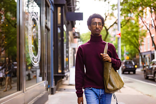 istock Urban Stroll: Young Man Walking in the City 2221917345