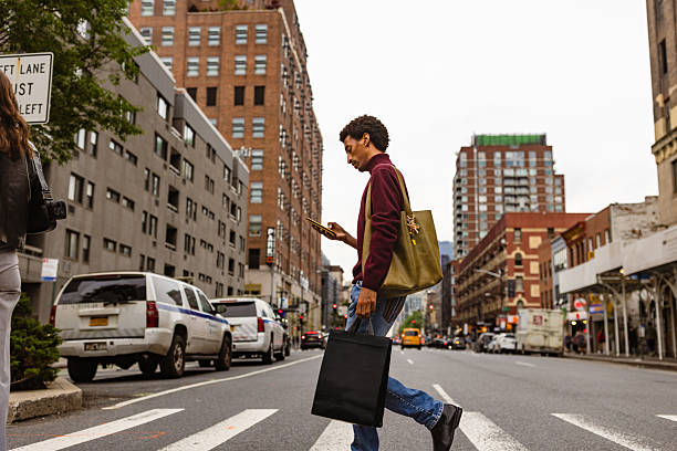 istock Urban Pedestrian Crossing Street Using Smartphone 2221917426