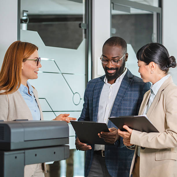 istock multicultural female and male colleagues stand by the copy machine 2221918464