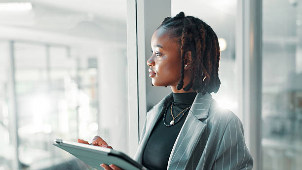 istock Black woman, business and thinking with tablet for idea, brainstorming or networking. Opportunist, person and tech for problem solving notes, research and reflection by glass or space for future 2221919154