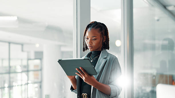 istock Business, black woman and tablet in office with internet connection for networking, communication or email. Corporate, serious person and technology for flare, search and planning online with space 2221919156