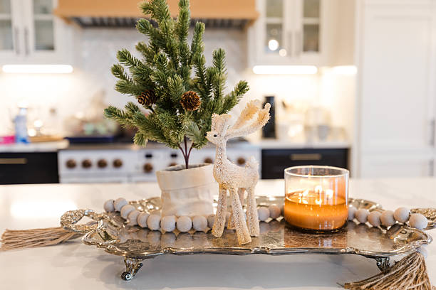 Cozy Christmas kitchen island centerpiece.  Candle, reindeer figurine, and mini pine tree.