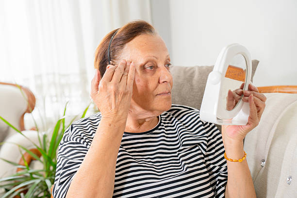 istock Mature woman doing skincare routine while sitting on a sofa at home 2221921043