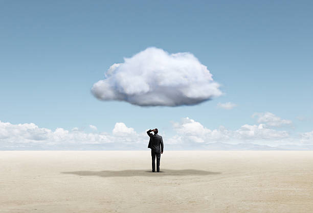 istock Man Looking Up At Cloud Directly Above Him 2221923594