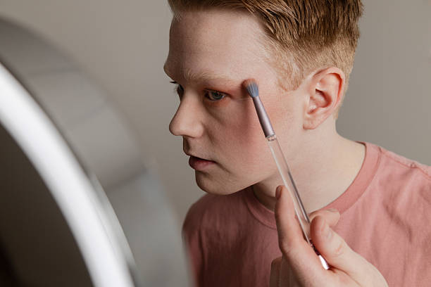 istock A Close-up of A Young Man Applying Eyeshadow in Front of Mirror 2221925009
