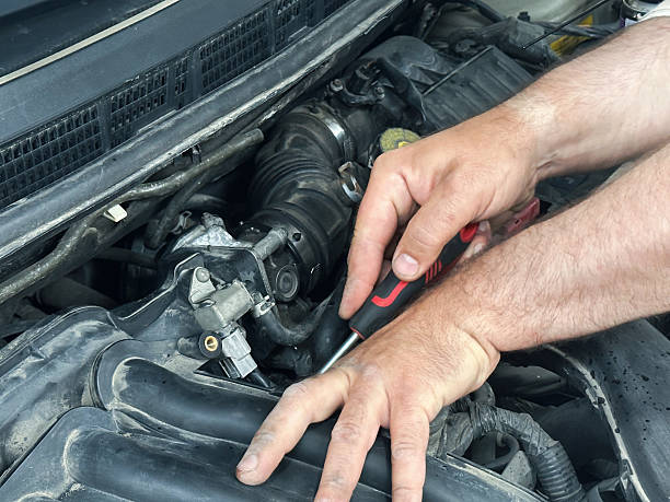 istock Car engine repair maintenance mechanic working with screwdriver tool on vehicle motor, automotive service 2221927466