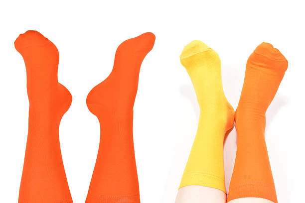 istock Orange socks on woman foot isolated on white background. 2221928986
