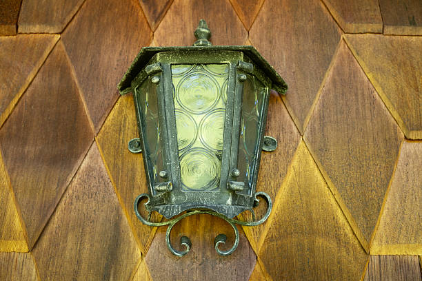 Vintage wall lantern on wooden house facade in country style