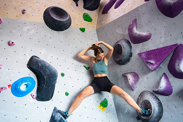 istock Rest Moment During Climb – Female Athlete on Colorful Wall 2221930316