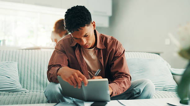istock Budget, home or man bookkeeping with notes, diary or finance statement for household bills or mortgage. Financial paperwork, profit or person writing banking info for investment, report or savings 2221931990