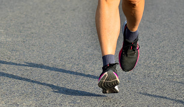 istock Lady Marathon Runner's Legs in Mid Air 2221932030