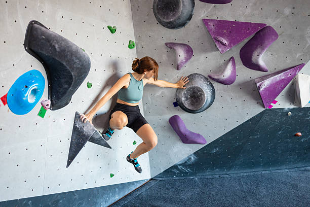istock Female Climber on Colorful Bouldering Wall 2221932261