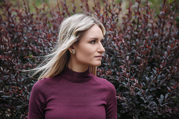 Young woman looking away with a serious expression in a park