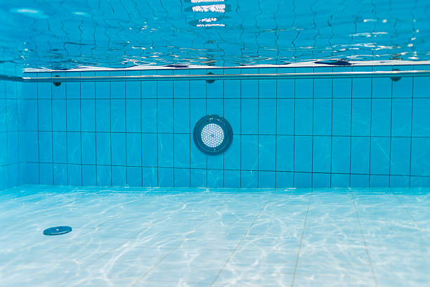 istock Clean blue water in a swimming pool, view from under the water. 2221934340