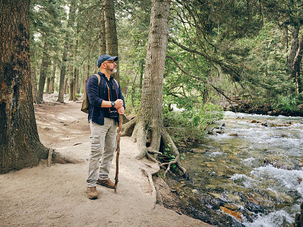 A mature aged hispanic man, hiking alone in a wilderness area. Utah, USA.