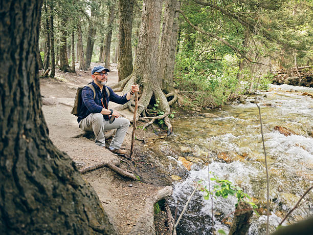 A mature aged hispanic man, hiking alone in a wilderness area. Utah, USA.