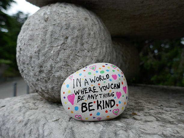 istock Supporting stone ball in statue with be kind kindness rock 2221938158