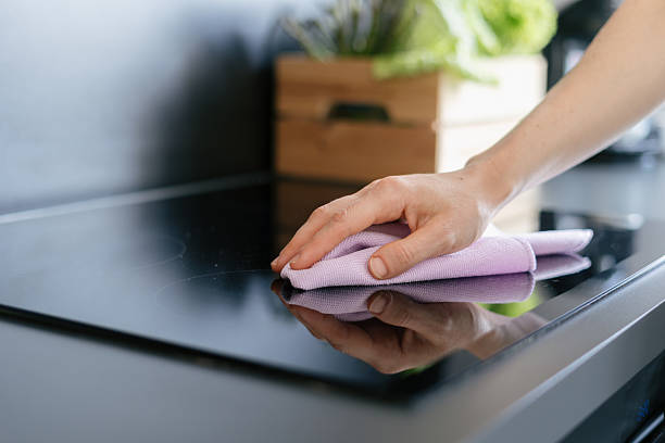 istock Modern kitchen cleaning with a woman using a cloth on the countertop 2221945671