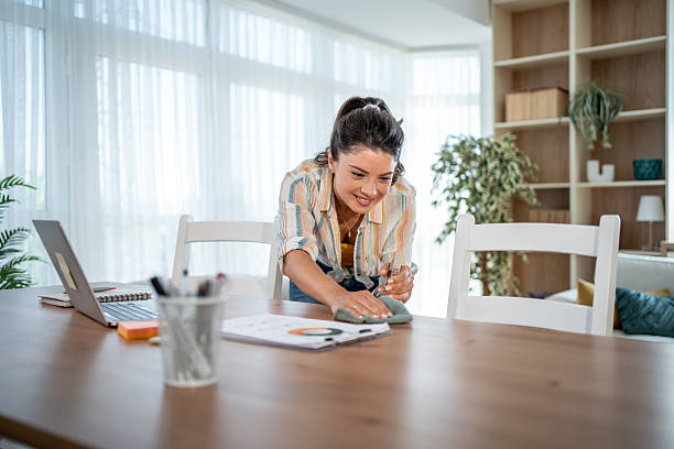 istock Woman cleaning dining table with disinfectant spray and cloth 2221950806