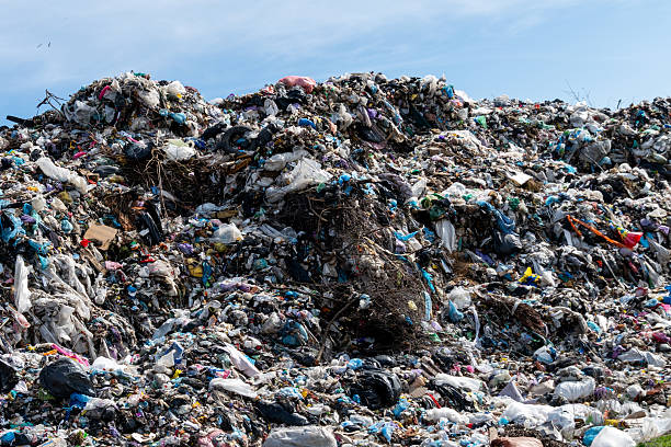 istock Immense Landfill Heap Under Blue Sky Displaying Waste and Environmental Issues 2221952448