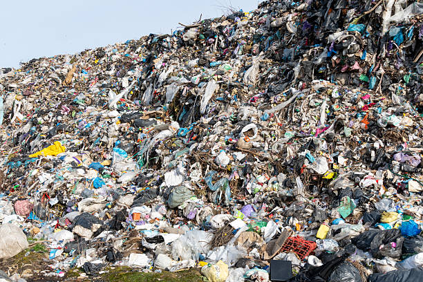 istock Overfilled Landfill Site with Plastic Bags and Discarded Objects Under Bright Sky 2221952469