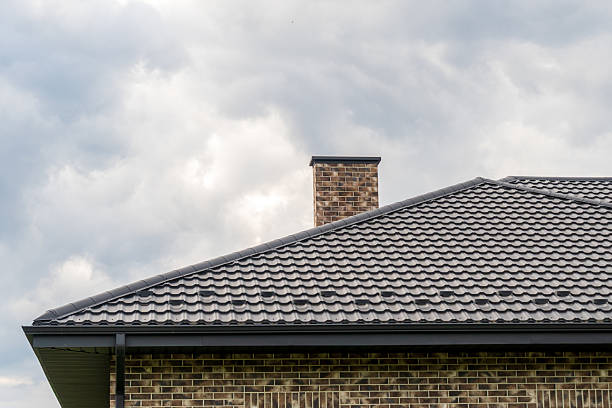 istock New Home Construction Showing Roof Tiles and Brick Chimney Stack Against Overcast Sky 2221952485