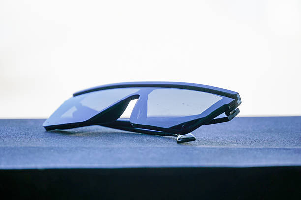 istock Stylish Sunglasses with Reflective Lenses Resting on a Textured Surface 2221952486