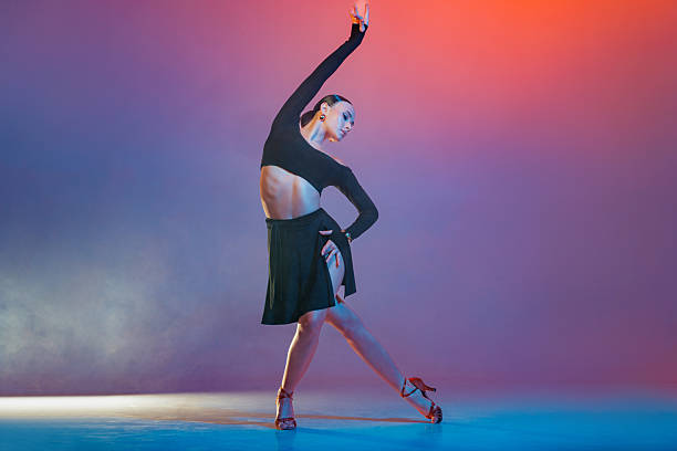 istock Latin Female Dancer in Black Performing Artistic Graceful Pose Studio Modern Latin American Dance 2221953918