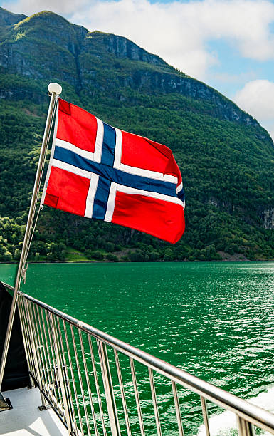 istock Norwegian flag flying on a boat in Naeroyfjord 2221954792