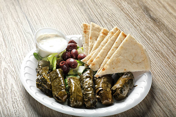 Stuffed grape leavesın plate on wooden table