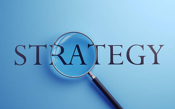 istock StrategyText Selected with Metallic Magnifying Glass on Soft Yellow Background 2221960401
