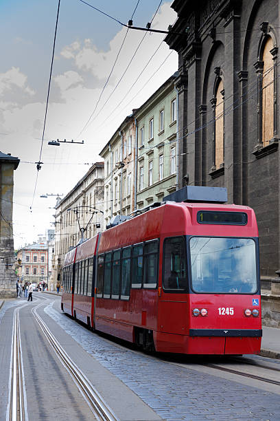 istock A Vibrant Red Tram Navigating Through a Historic Urban Landscape Rich with Architectural Charm and Dynamic City Life 2221962109