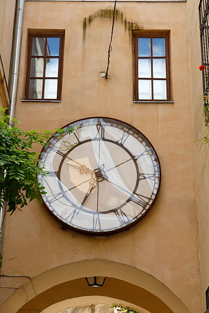 istock A Beautifully Designed Clock Graces the Wall of an Arched Passageway, Adding Character and Charm to Architecture with Its Vintage Style and Distinctive Artistic Elements 2221964476