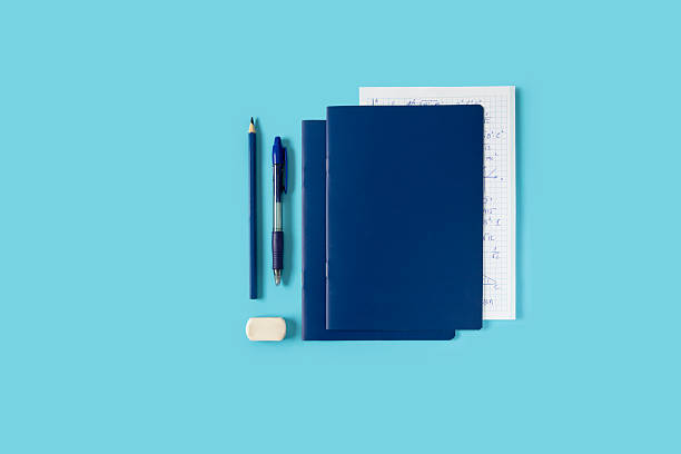 istock Back to school, education concept, notebook with math formulas paper, pen, pencil and eraser, stationary accessories on blue background 2221966077