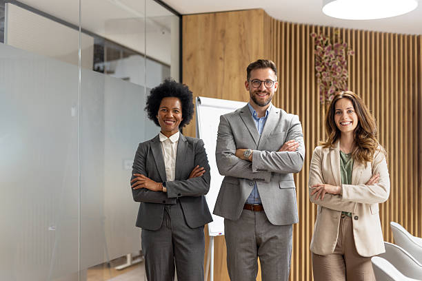 istock Smiling business team posing with confidence in modern office 2221966312
