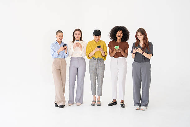 istock Cheerful businesswomen using smartphones on white background 2221966340