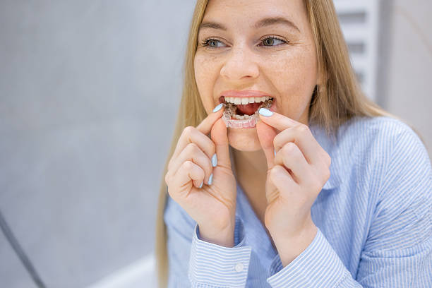 istock Smiling woman using invisible aligner for teeth correction and orthodontic treatment 2221966441