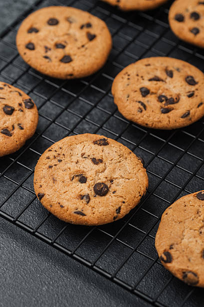 istock Freshly baked cookies cooling on a wire rack in a cozy kitchen setting 2221967015