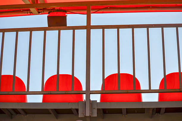 A metal railing with red chairs on it. The chairs are red and ar in Chișinău, Chisinau, Moldova